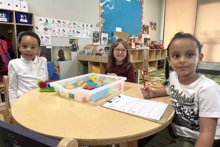 Happy children sitting at a table
